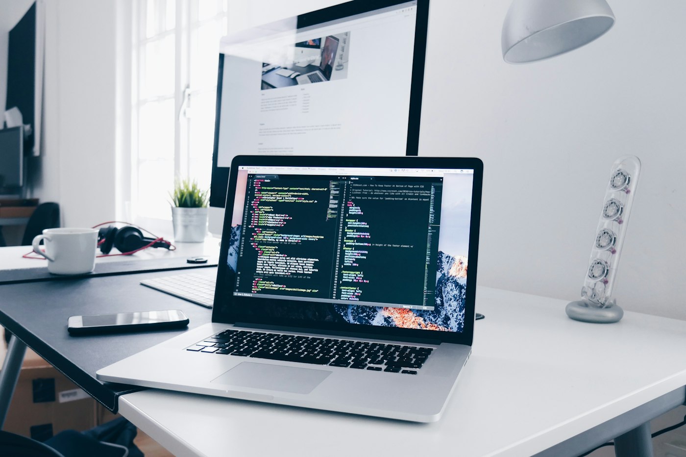 Developer workspace with code editor open on a laptop